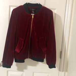 Red velvet with black trim zip front jacket. Side pockets  lined .